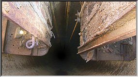 Looking down 435m deep Pozo Francisco de Paula between the cages