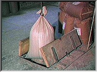 A sack of grain passing through the 'trapdoor'