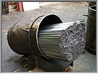 Bucket of metal strips - feed stock for the cut nail machines