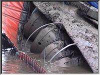 The sunken dredger with a protective bund around it.