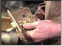 Fitting the levers to a brass ship lock